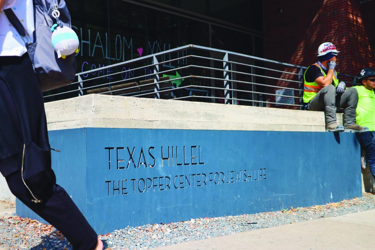 Construction workers eat lunch as students walk past the Texas Hillel Topper Center for Jewish Life on Oct. 4, 2023. Hillel is the largest Jewish campus organization in the world.