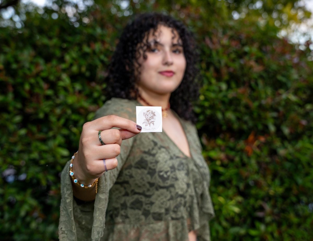 Sofia Alejandro, owner of Roses for Sofia wears jewelry she created on Nov. 7, 2023.