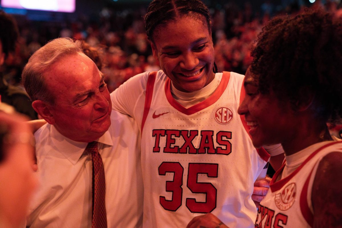 Head coach Vic Schaefer with forward Madison Booker (middle) and guard Rori Harmon (right) after Texas' win against South Carolina on Feb. 9, 2025. 