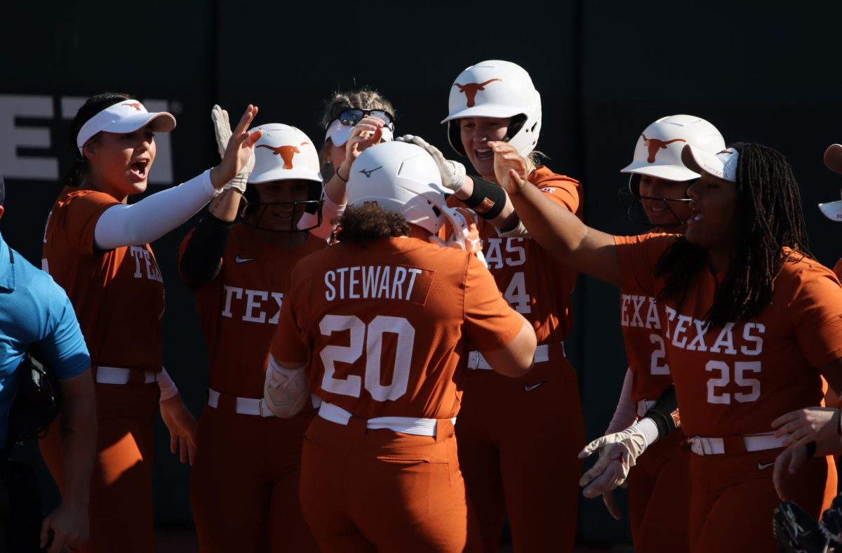 The Texas Softball team celebrates infielder Katie Stewart after a home run on March 1, 2024.