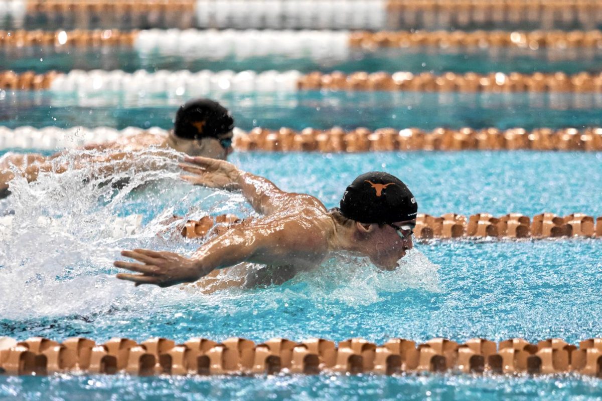 Swimmers compete in the Big 12 Swimming and Diving Championship at the Lee and Joe Jamail Texas Swimming Center on Feb. 25, 2022.
