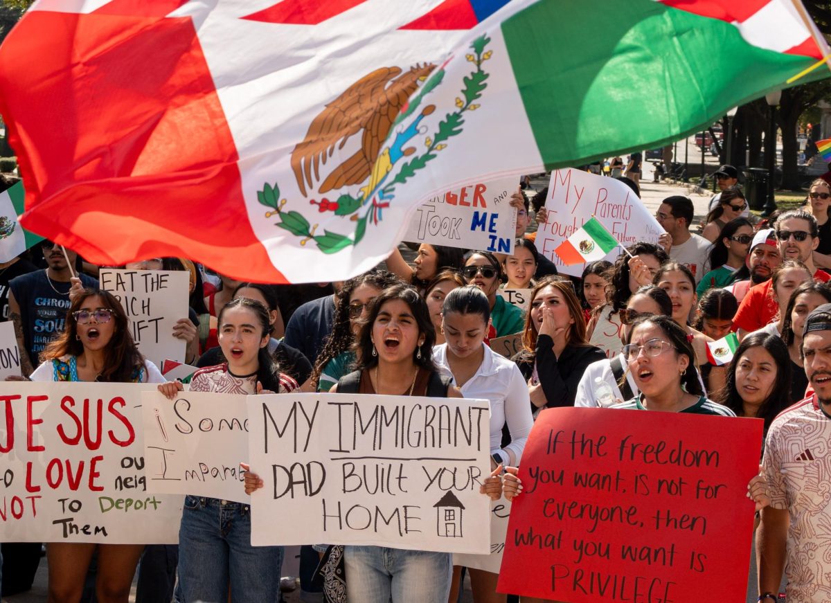 Protesters hold up signs outside of the Capitol at the Betas immigration protest on Feb. 8, 2025. 