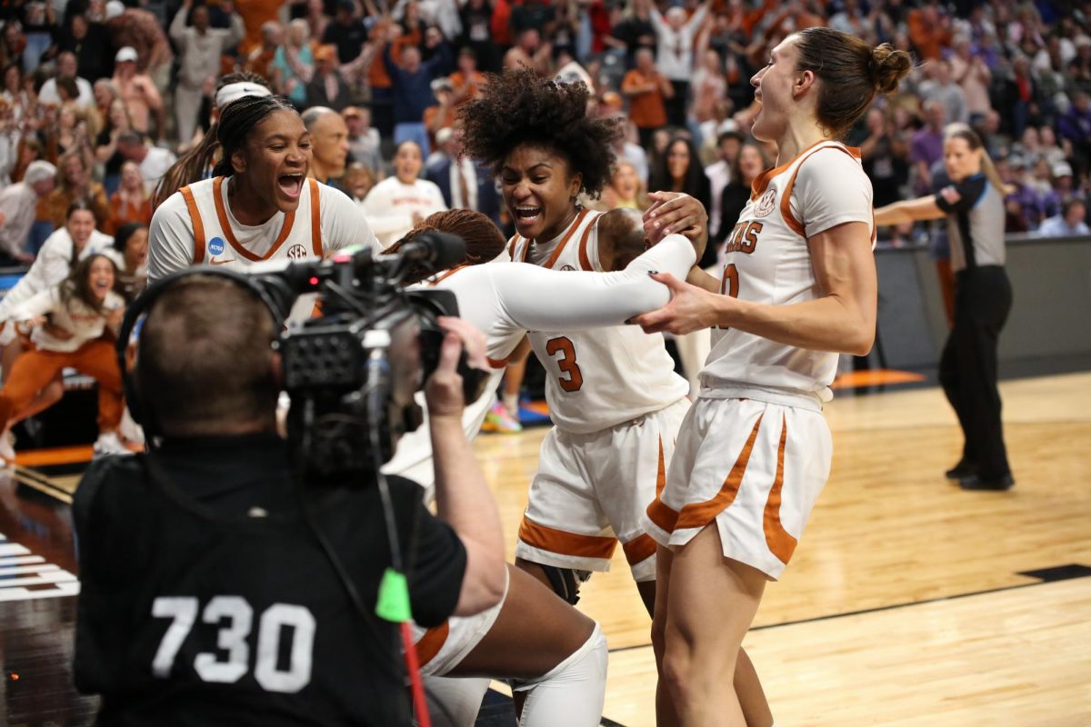 Madison Booker, Romi Harmon and Shay Holle lifting up center Kayla Oldacre after making a layup during the NCAA March Madness Elite Eight game in Birmingham, Alabama, on March 31, 2025.