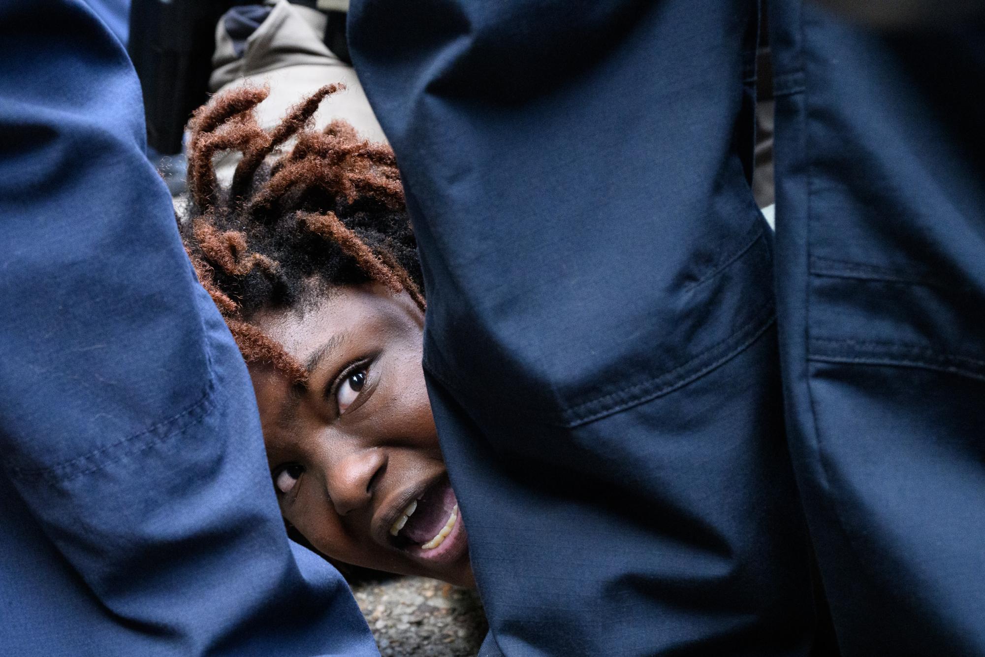 Law enforcement detain and zip-tie a student demonstrator on the UT Main Mall pavement during the pro-Palestine student walkout on Wednesday, April 24, 2024.